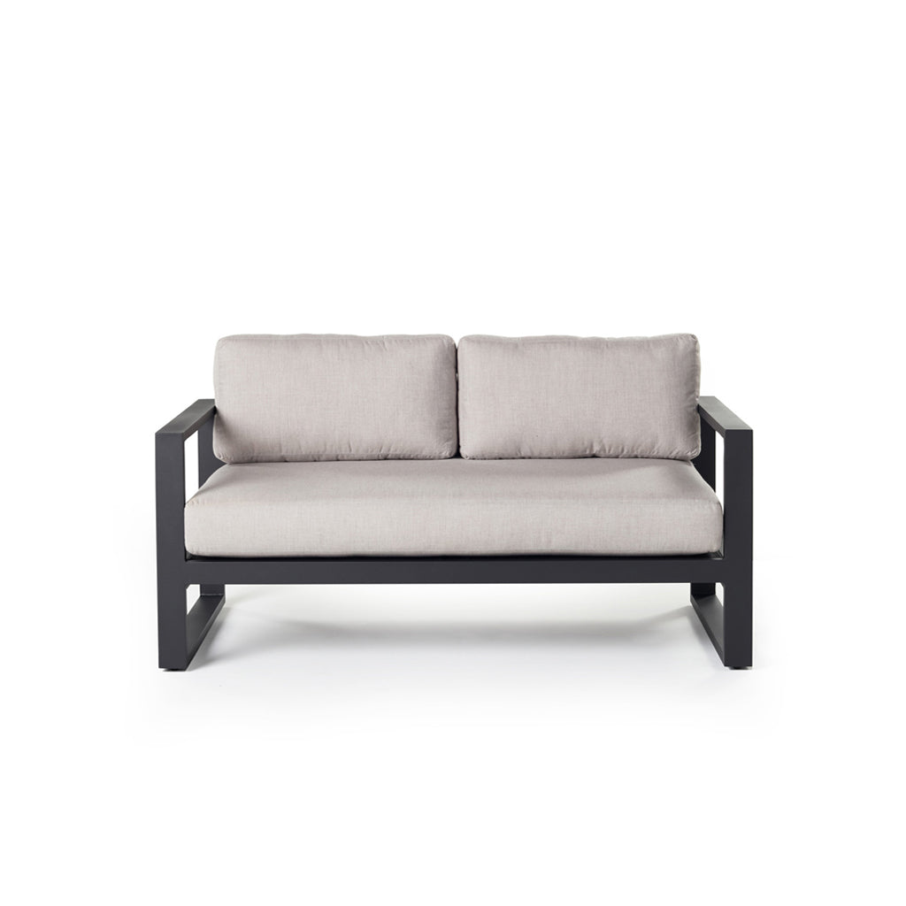 Belvedere Loveseat in Charcoal by Terra Outdoor Living features architectural lines, airy proportions, and deep weather-friendly cushions on a low-profile, durably finished aluminum frame with slatted detailing for drainage. Features squared-off arms wide enough to rest a drink on. One long seat cushion plus two back cushions complete a clean look. 