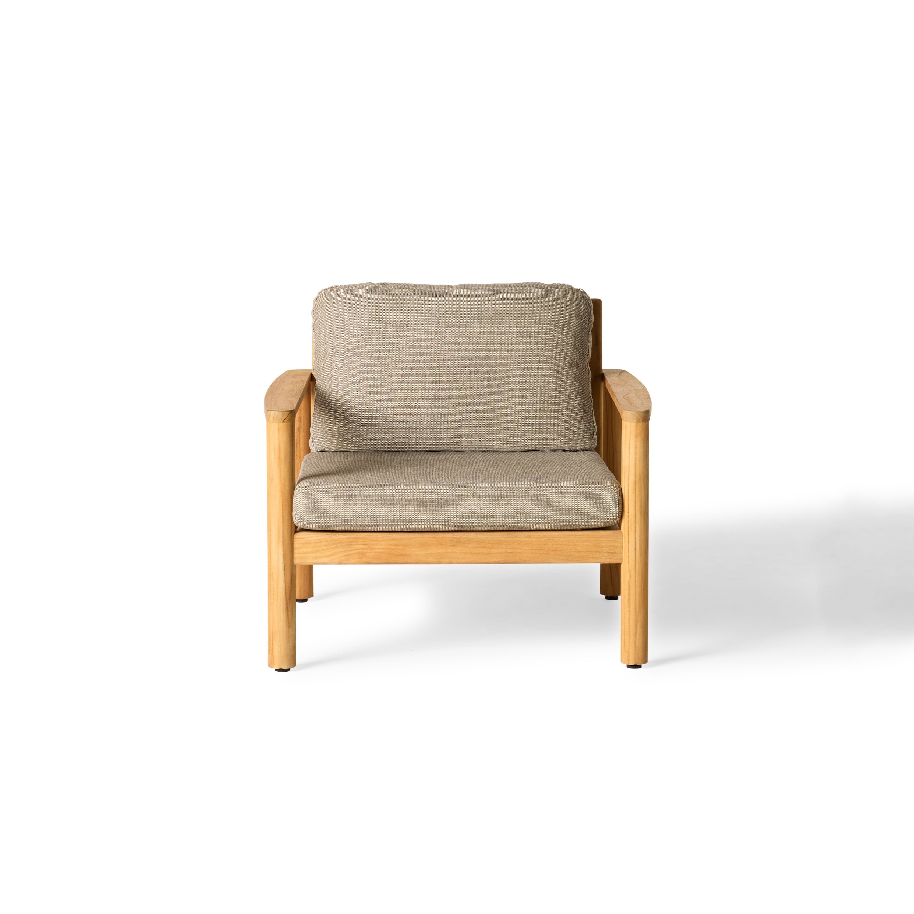 The Stinson Lounge Chair by Terra Outdoor Living with teak frame and Italian rope seat back, shown with weather-friendly cushions—features gently curved lines and vertical slats for a wraparound silhouette inspired by a curved beach; includes one seat cushion and one plush back cushion.