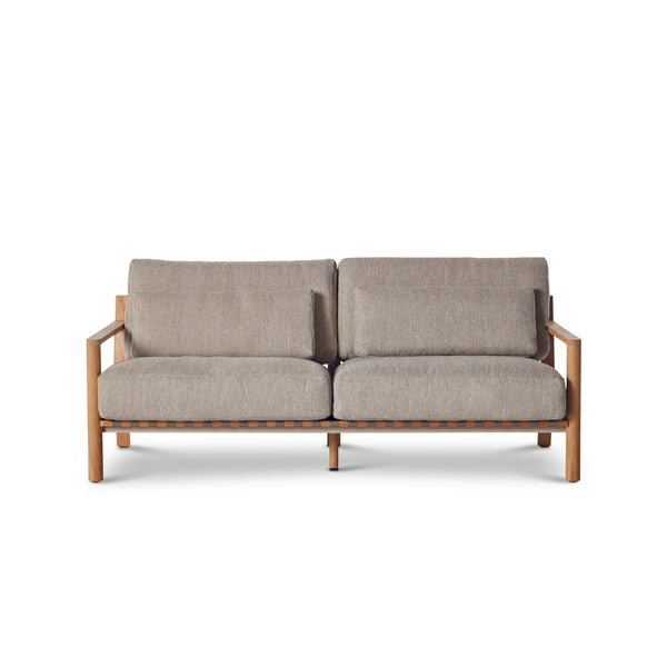 Aptos Sofa by Terra Outdoor Living — crafted from premium plantation-grown teak, featuring a European-inspired compact silhouette and angled back for comfort; includes two seat cushions, two back cushions, and two lumbar pillows in weather-friendly olefin, offering a perfect balance of softness and support.