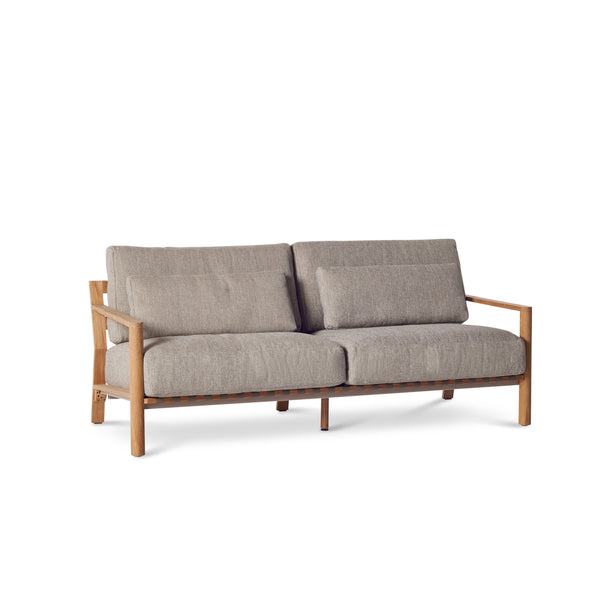 Aptos Sofa by Terra Outdoor Living — crafted from premium plantation-grown teak, featuring a European-inspired compact silhouette and angled back for comfort; includes two seat cushions, two back cushions, and two lumbar pillows in weather-friendly olefin, offering a perfect balance of softness and support.