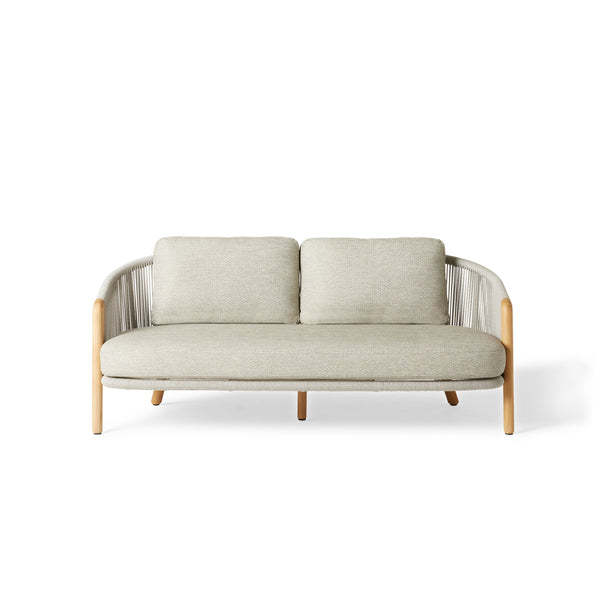 Avila Loveseat by Terra Outdoor Living — features a sculptural frame with premium teak legs, wraparound sides and back crafted from durable all-weather rope over powdercoated aluminum, paired with plush, low-profile cushions in a clean, modern silhouette made for outdoor lounging.