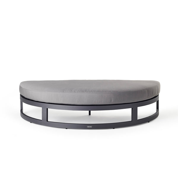 Belvedere Daybed Ottoman by Terra Outdoor Living, crafted from durably finished aluminum with thick Sunbrella® cushions, features a modular design with a separate backrest and ottoman for customizable comfort and versatility.  Ottoman is half-moon shaped, with straight side to fit against the back part of the configuration. 