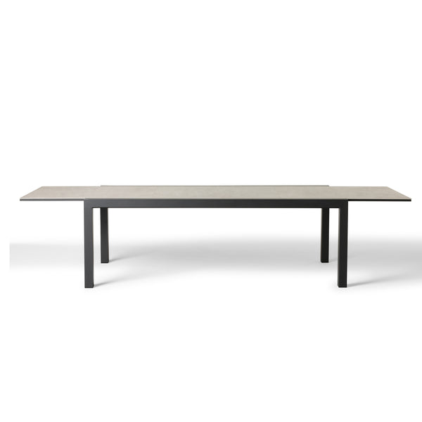 Del Mar Dining Table by Terra Outdoor Living — features an aluminum frame in 'Charcoal' with a ceramic top; seats up to 12 comfortably and includes a convenient extendable leaf that nests under the table when not in use, perfect for dining and entertaining. 