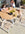 A mother and daughter set the Portola dining table in white aluminum