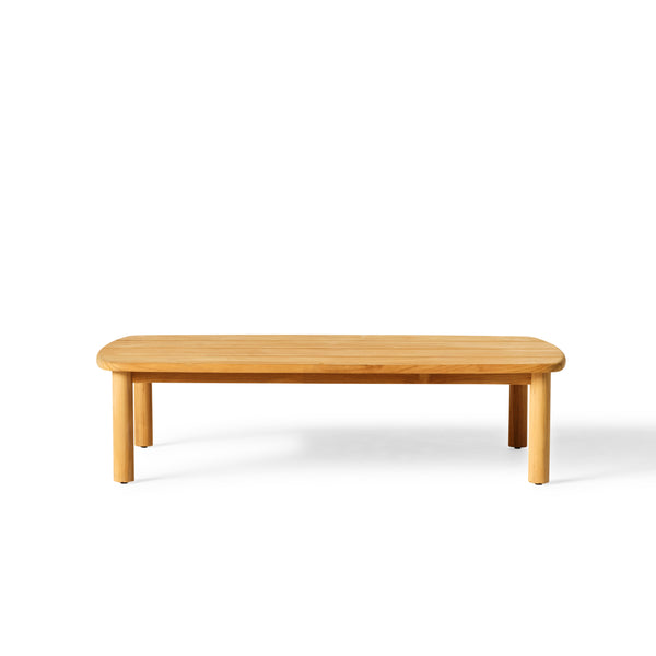 Stinson Coffee Table by Terra Outdoor Living made of premium teak in a natural finish, featuring gently curved edges. The slatted tabletop design allows for water drainage and offers ample space for drinks and snacks.