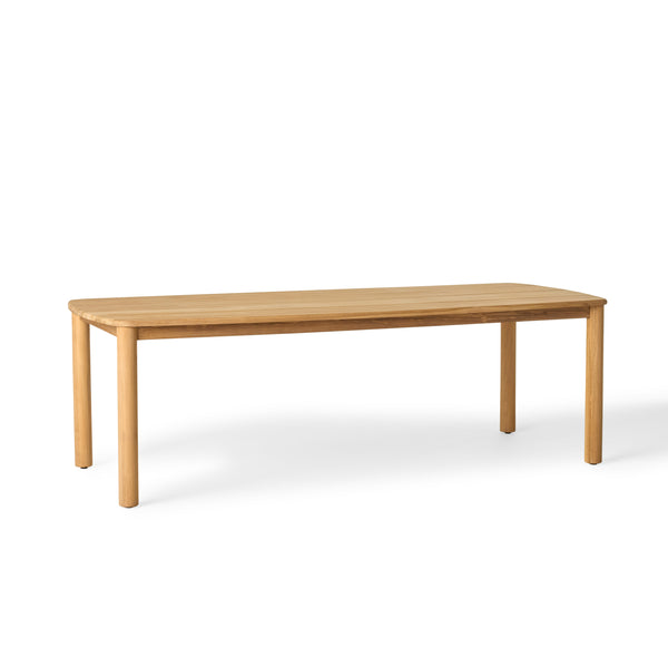 Stinson Dining Table crafted from premium teak in a natural finish, featuring curved edges and a spacious slatted tabletop seats up to 8 comfortably and allows water to drain, ideal for outdoor dining.